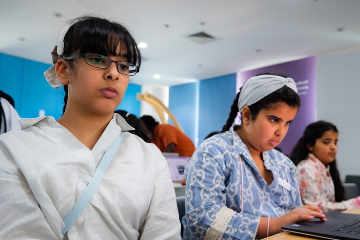 Students working on laptops during an Ibtechar AI session