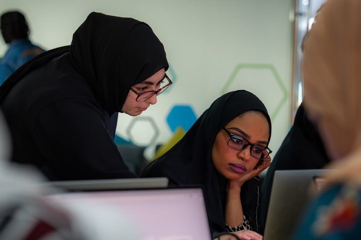 Two participants working together on a laptop during an Ibtechar workshop