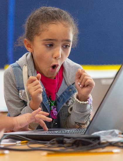 A young learner reacting with excitement during a hands-on session