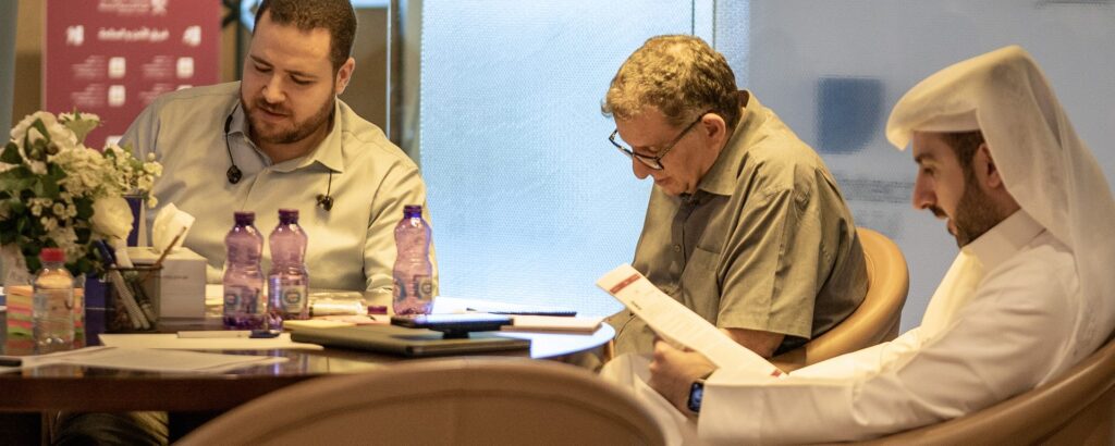 Participants reviewing documents at an Ibtechar roundtable