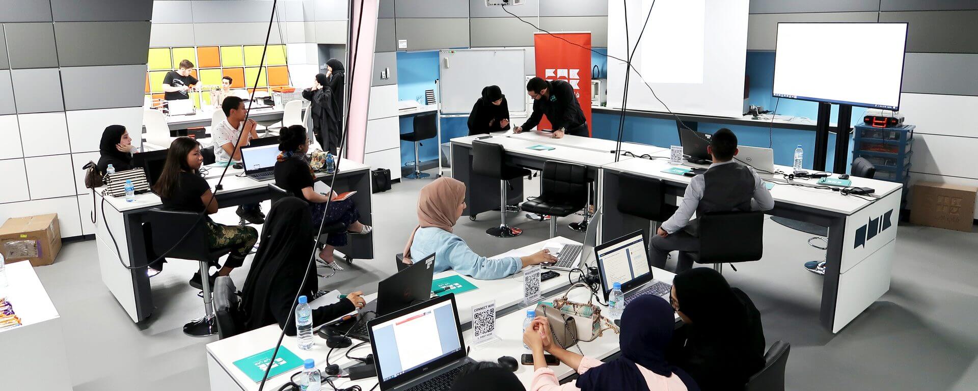 Users working at the benches inside the QBIC Fab Lab